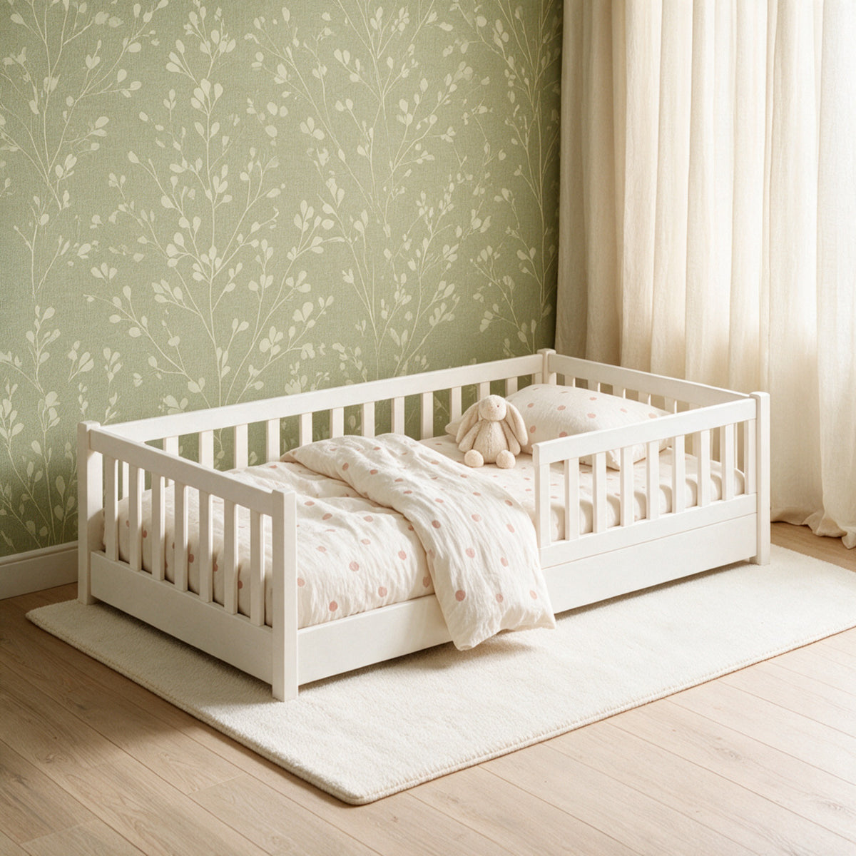 Cama Montessori Martina Junior en blanco, en un cuarto con papel tapiz verde salvia y cortinas de lino